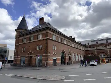 Oversigtsbillede af hjørne tårn gade facade på gadefacaden, i tegl, mørtel, natursten og skifer.